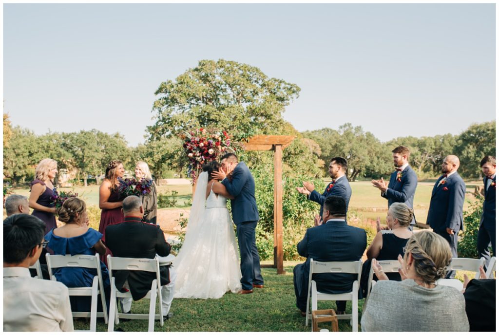 outdoor wedding ceremony at cimarron hills wedding venue with jewel toned florals