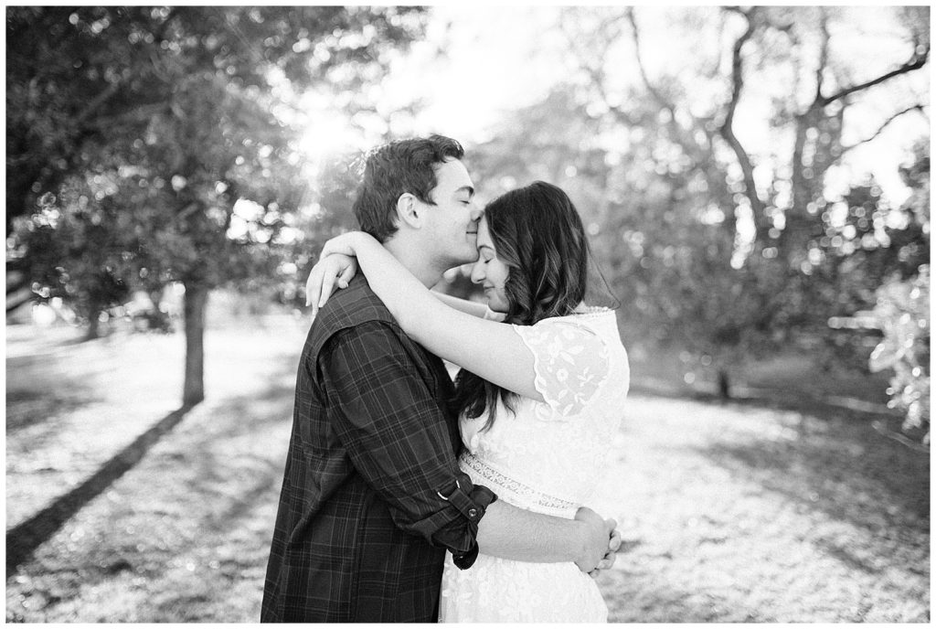 Engaged couple posing for portraits in the fall at the Lubbock Memorial Arboretum