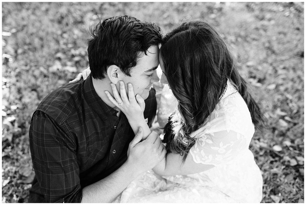 Engaged couple posing for portraits in the fall at the Lubbock Memorial Arboretum