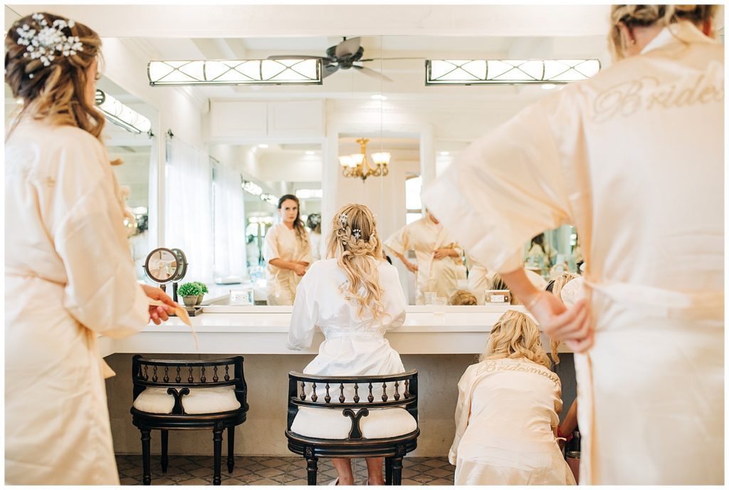 bride and bridesmaids getting ready in robes