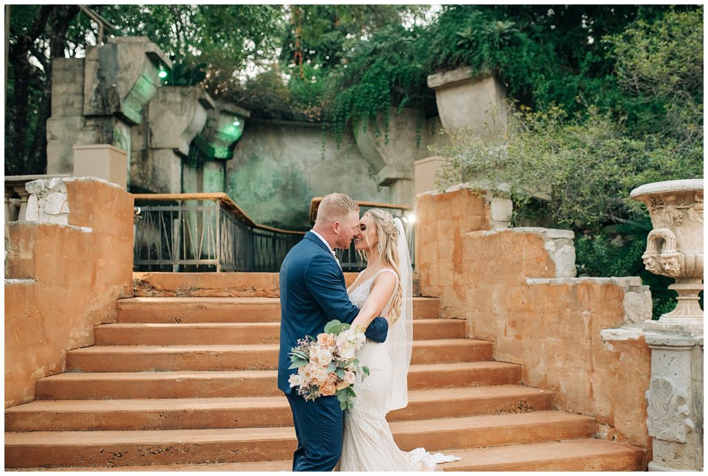 bride and groom portraits, groom wearing navy suit, bride holding blush bridal bouquet