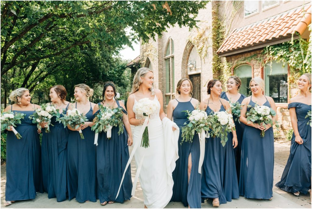 bride with bridesmaids wearing dusty blue dresses