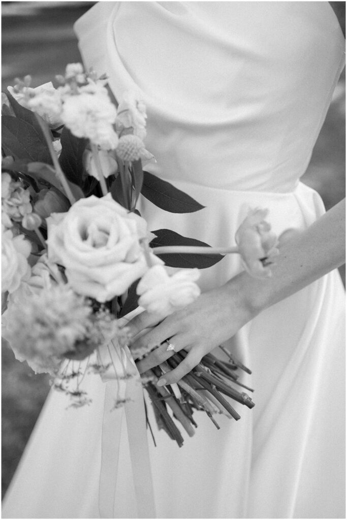 black and white bridal details, bride holding bouquet with ring