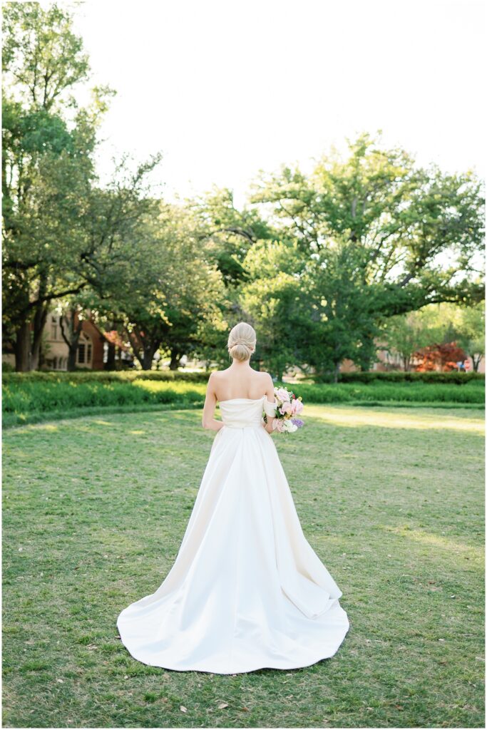 bride and the back of her dress in park
